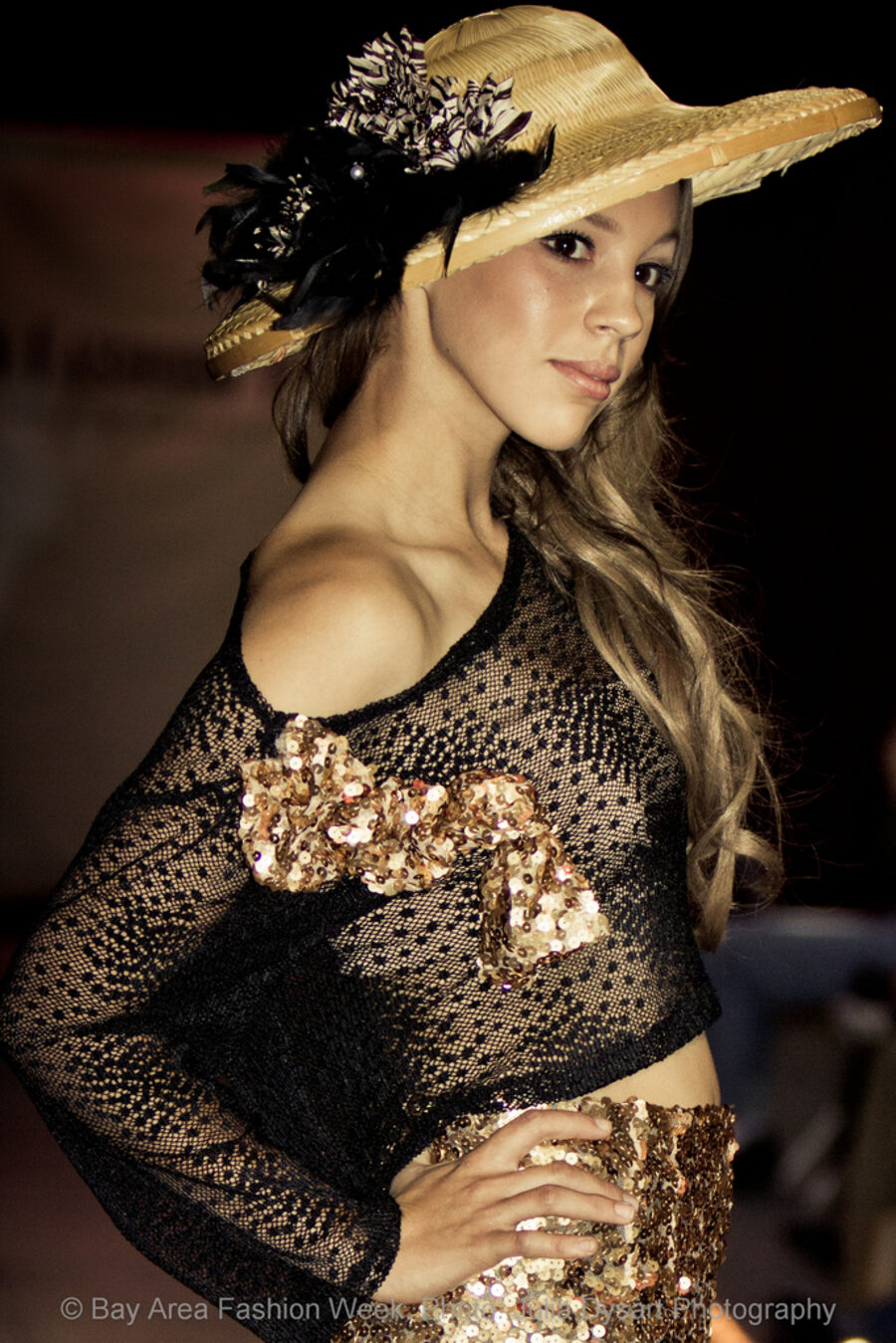 Black and gold evening look with feathered hat