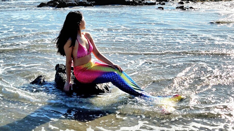 Rainbow ombre mermaid tail on the shore